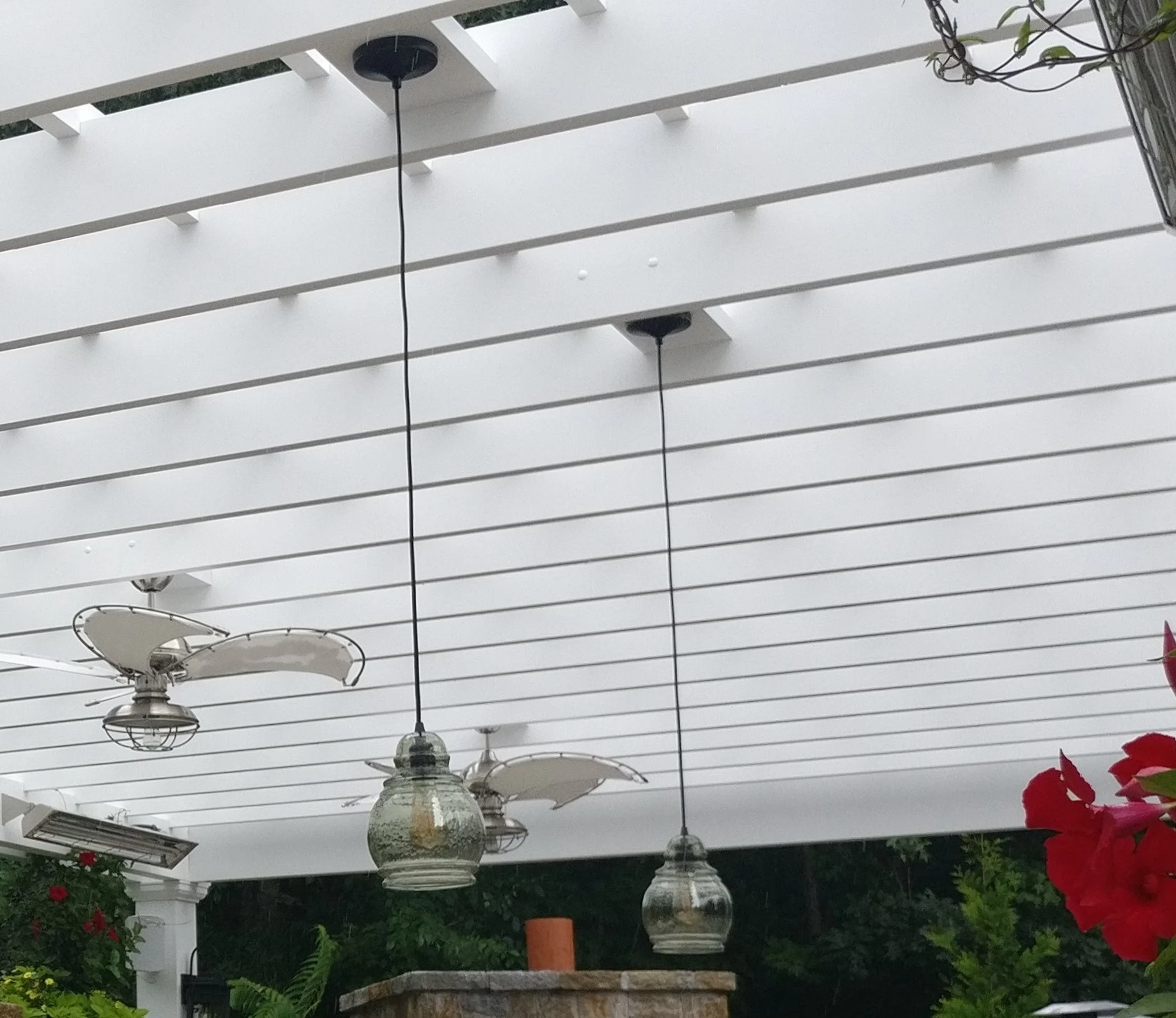 A pendant light hangs from a fan block